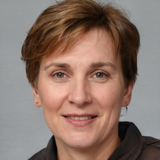 Joyful white adult female with medium  brown hair and grey eyes