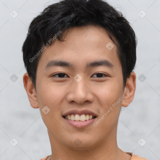 Joyful asian young-adult male with short  black hair and brown eyes