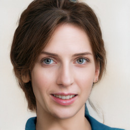 Joyful white young-adult female with medium  brown hair and blue eyes