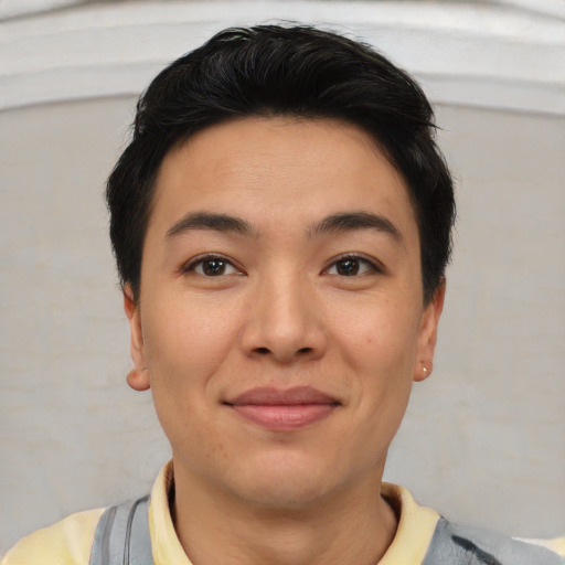 Joyful asian young-adult male with short  brown hair and brown eyes