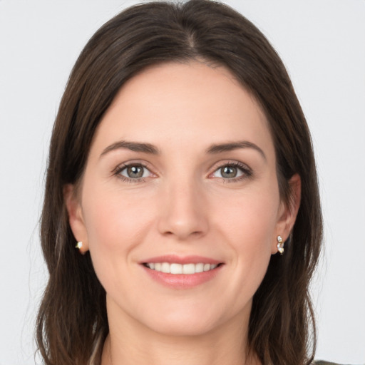 Joyful white young-adult female with long  brown hair and grey eyes