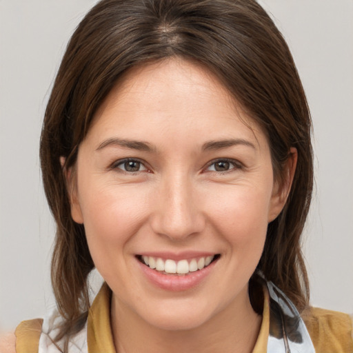 Joyful white young-adult female with medium  brown hair and brown eyes