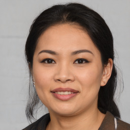 Joyful asian young-adult female with medium  brown hair and brown eyes