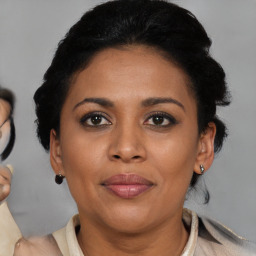 Joyful black adult female with short  brown hair and brown eyes