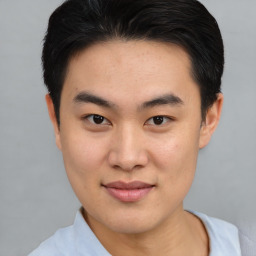 Joyful asian young-adult male with short  black hair and brown eyes