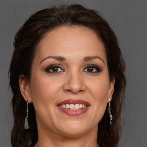 Joyful white adult female with long  brown hair and brown eyes