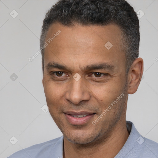 Joyful latino adult male with short  black hair and brown eyes