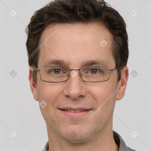 Joyful white adult male with short  brown hair and grey eyes