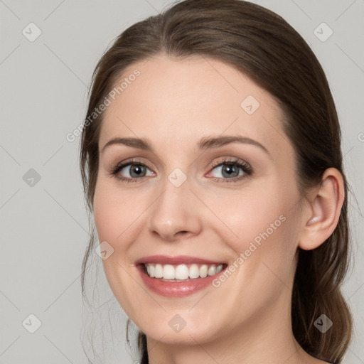 Joyful white young-adult female with long  brown hair and grey eyes