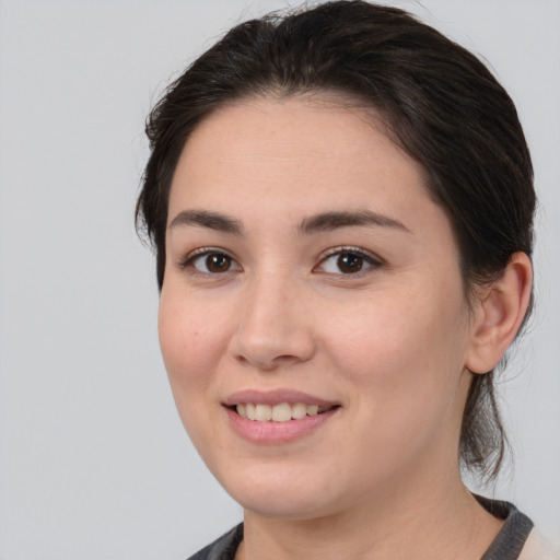 Joyful white young-adult female with medium  brown hair and brown eyes