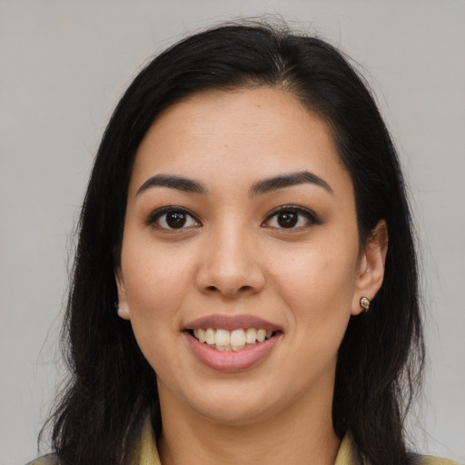 Joyful latino young-adult female with long  brown hair and brown eyes