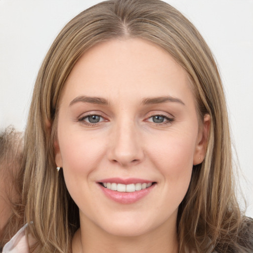 Joyful white young-adult female with long  brown hair and grey eyes