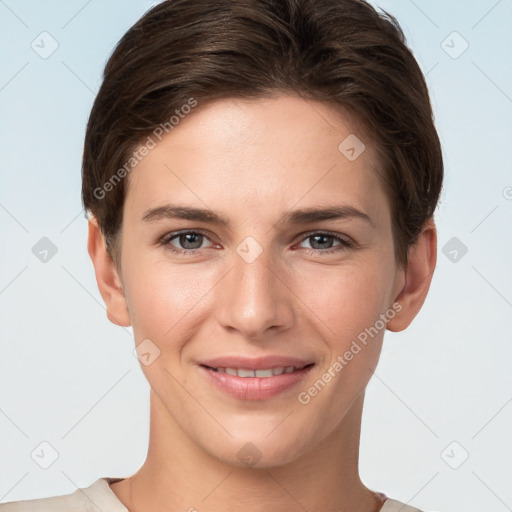 Joyful white young-adult female with short  brown hair and grey eyes