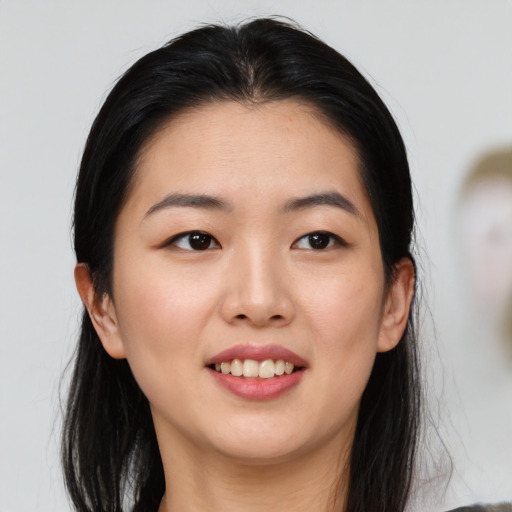 Joyful asian young-adult female with medium  brown hair and brown eyes