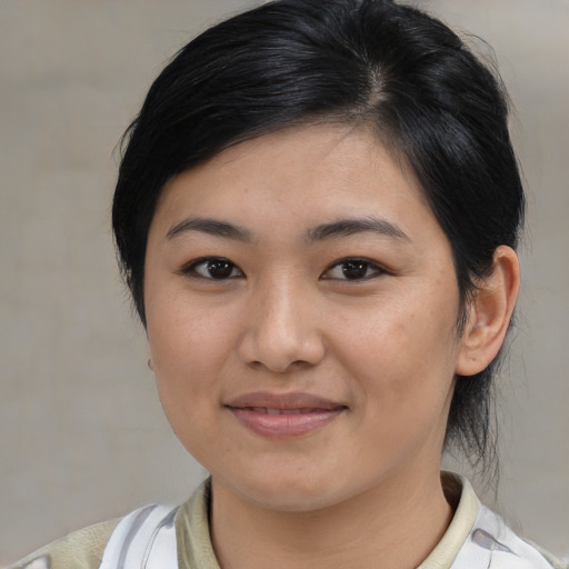 Joyful asian young-adult female with medium  brown hair and brown eyes