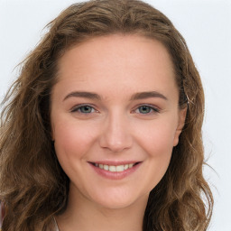 Joyful white young-adult female with long  brown hair and green eyes