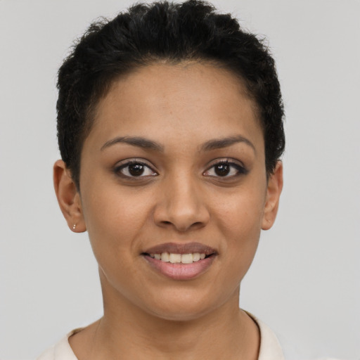 Joyful latino young-adult female with short  brown hair and brown eyes