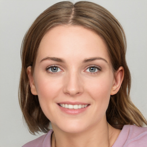 Joyful white young-adult female with medium  brown hair and blue eyes