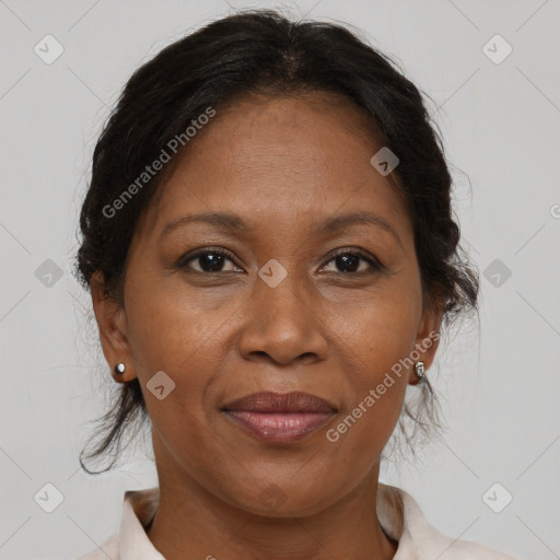 Joyful black adult female with medium  brown hair and brown eyes