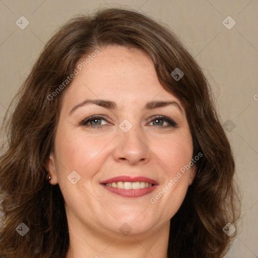 Joyful white adult female with long  brown hair and brown eyes