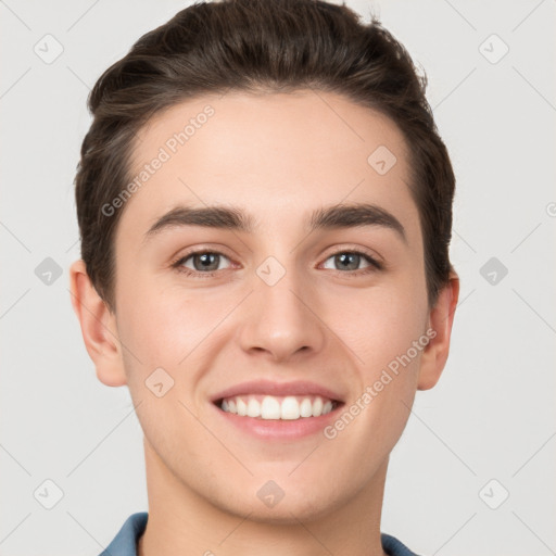 Joyful white young-adult male with short  brown hair and grey eyes