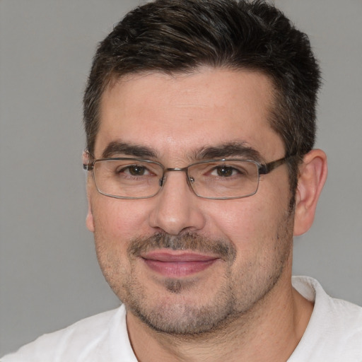 Joyful white adult male with short  brown hair and brown eyes