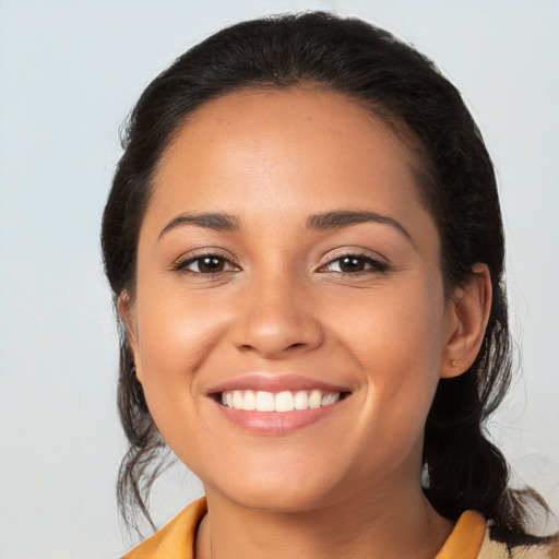 Joyful latino young-adult female with medium  black hair and brown eyes