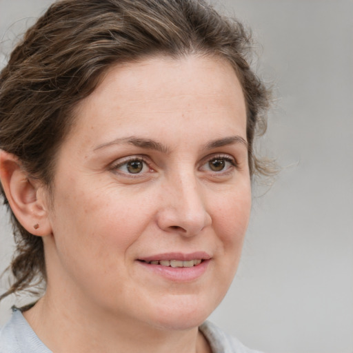 Joyful white adult female with medium  brown hair and grey eyes