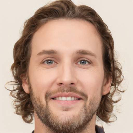 Joyful white young-adult male with short  brown hair and green eyes