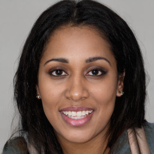Joyful latino young-adult female with long  black hair and brown eyes