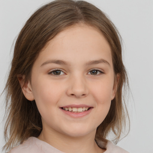 Joyful white child female with medium  brown hair and brown eyes