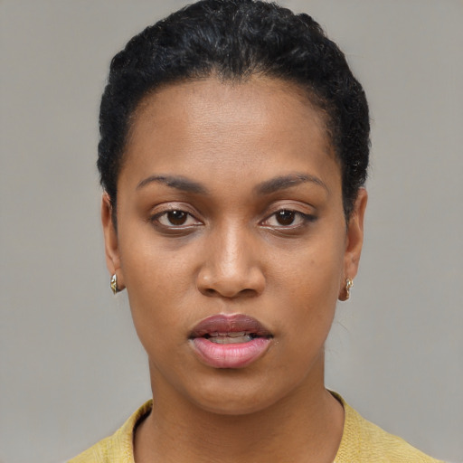 Joyful black young-adult female with short  black hair and brown eyes