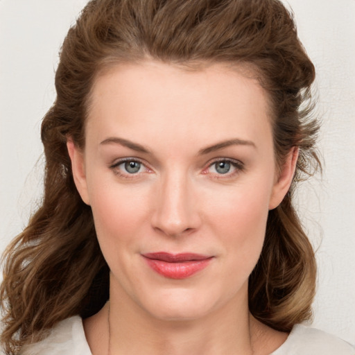 Joyful white young-adult female with medium  brown hair and green eyes