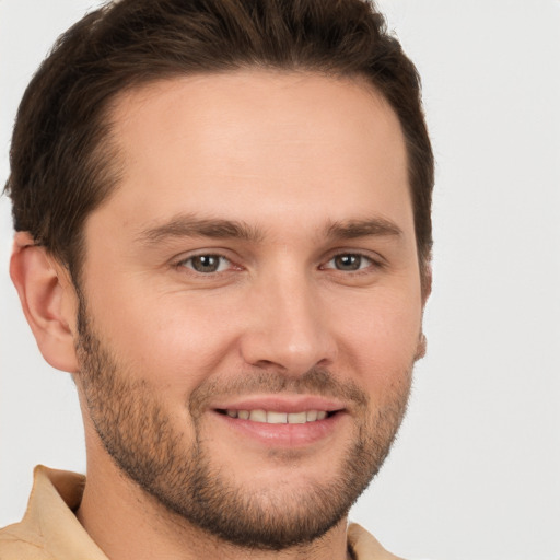 Joyful white young-adult male with short  brown hair and brown eyes