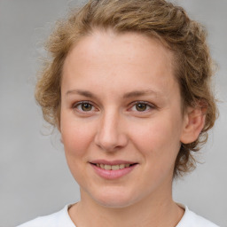 Joyful white young-adult female with medium  brown hair and blue eyes