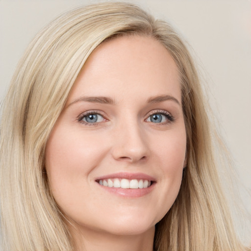 Joyful white young-adult female with long  brown hair and blue eyes