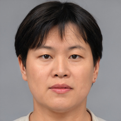 Joyful asian adult female with short  brown hair and brown eyes