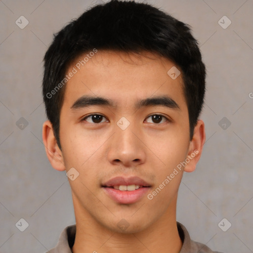 Joyful asian young-adult male with short  brown hair and brown eyes