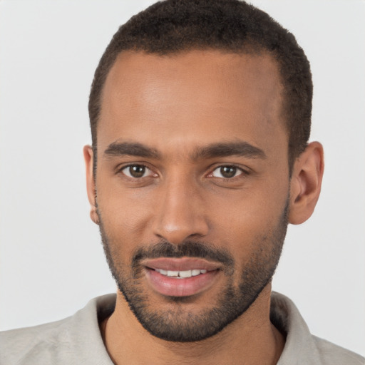 Joyful black young-adult male with short  brown hair and brown eyes