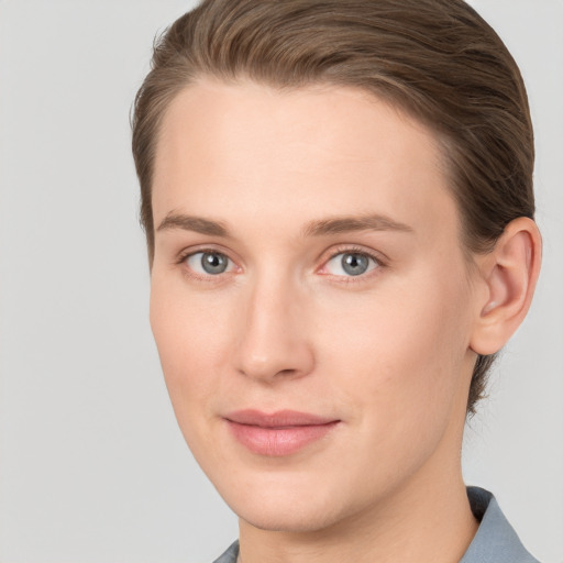 Joyful white young-adult female with short  brown hair and grey eyes