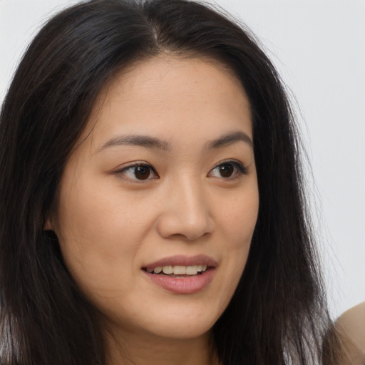 Joyful asian young-adult female with long  brown hair and brown eyes