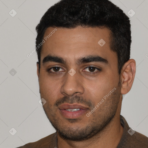 Joyful latino young-adult male with short  black hair and brown eyes