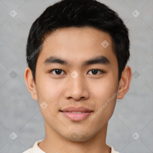 Joyful asian young-adult male with short  black hair and brown eyes