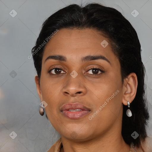 Joyful black young-adult female with long  brown hair and brown eyes