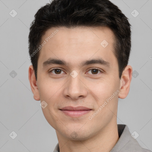 Joyful white young-adult male with short  black hair and brown eyes