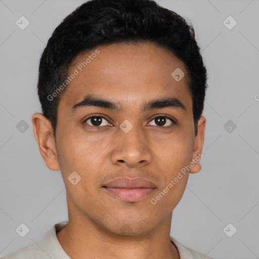 Joyful latino young-adult male with short  black hair and brown eyes