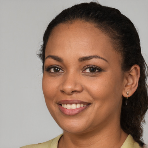 Joyful latino young-adult female with medium  brown hair and brown eyes