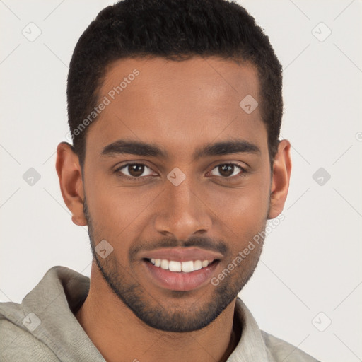 Joyful black young-adult male with short  brown hair and brown eyes