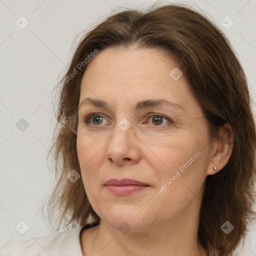 Joyful white adult female with medium  brown hair and brown eyes