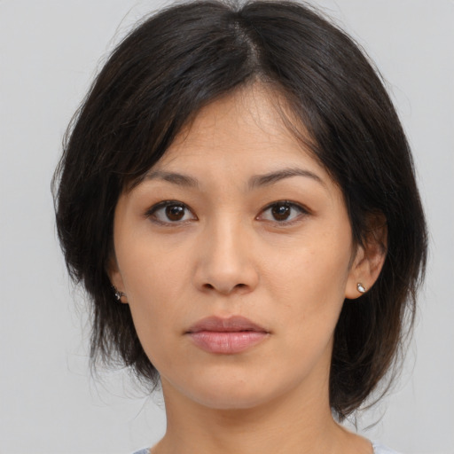 Neutral asian young-adult female with medium  brown hair and brown eyes